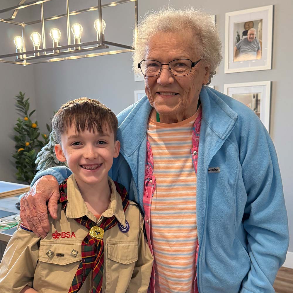 A resident enjoying a heartwarming intergenerational visit at Cherry Creek AFH.