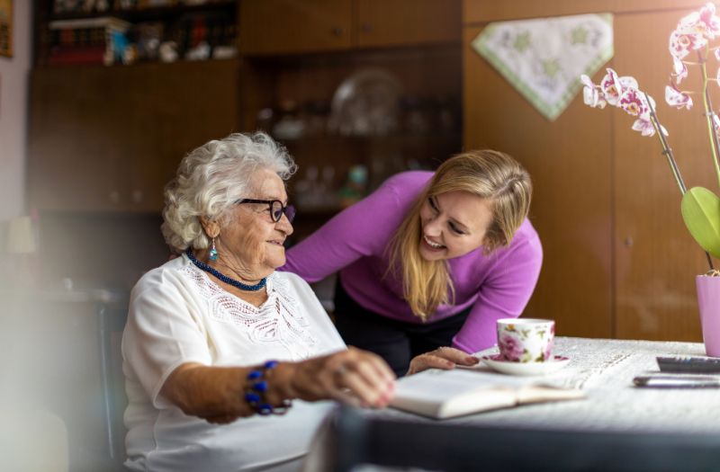 Caregiver providing 1-on-1 senior care to a resident in a Kennewick home setting.